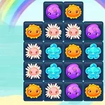 Gioco di blocchi colorati con forme di fiori e faccine sorridenti, su sfondo arcobaleno